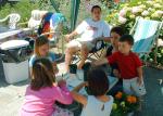 Gathering in the backyard while children arrive. Each child could decorate a flower pot and later plant a flower in it to take h
