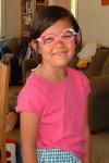 Maya (7 yrs) with homemade glasses and missing front teeth
(July 2003)
