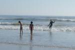 Carla and Maya 2006-16 - John surfing and Carla and Maya looking for whole sand dollars in the surf near Morro Rock.